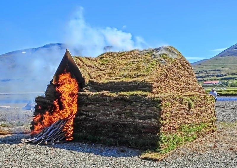 Turf house burning at the experimental archaeology festival 2024 at Eiríksstaðir, Iceland