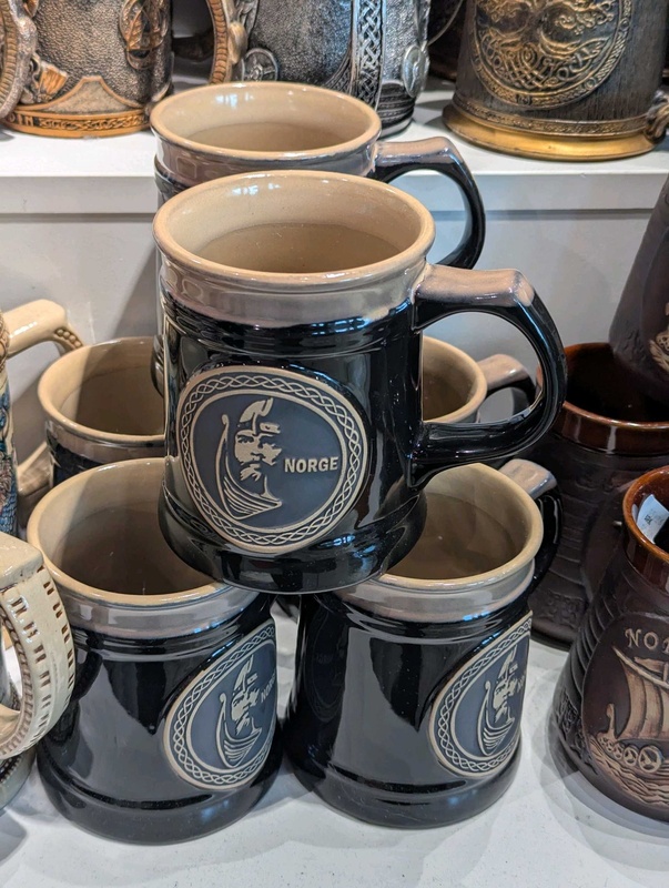 Black and beige ceramic souvenir mug with Viking motif