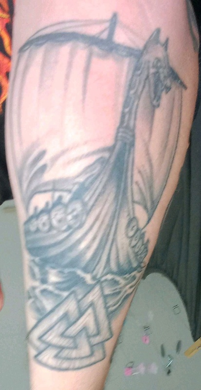 Tattoo of non-historical viking ship and a Valknut