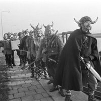 The Norsemen pose with their weapons