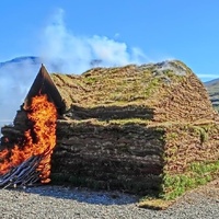 Turf house burning at the experimental archaeology festival 2024 at Eiríksstaðir, Iceland